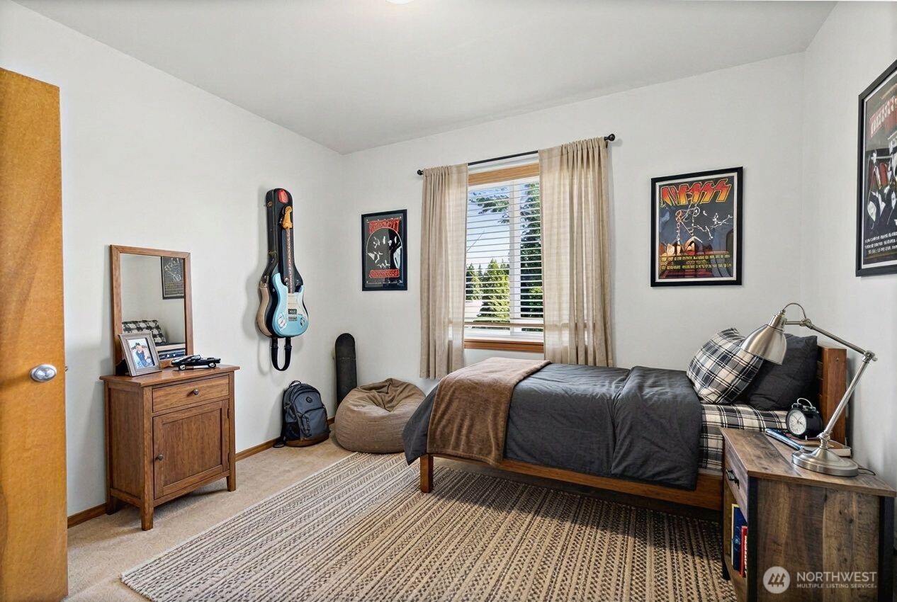 1496 Aberdeen Avenue Northeast Renton, WA 98056 - Photo 21 of 28 a bedroom with a bed and wooden floor