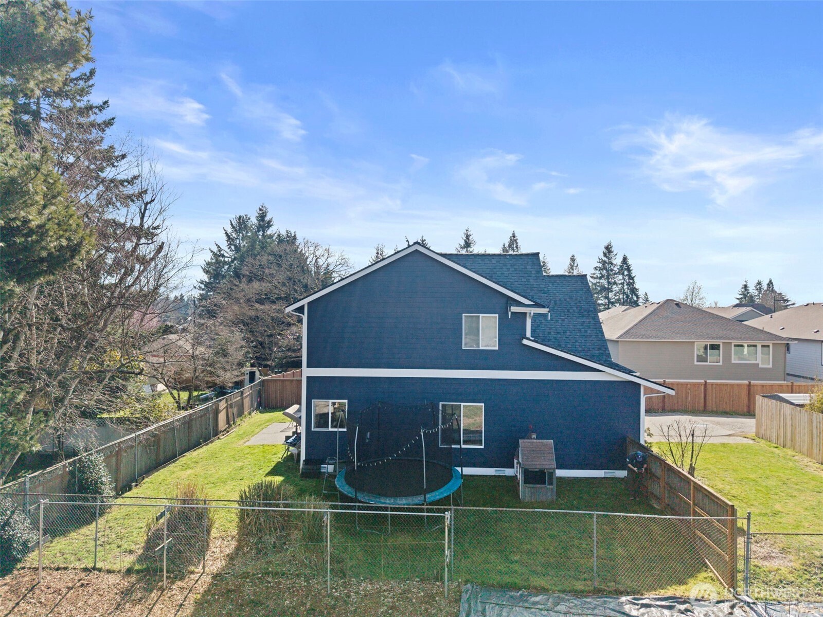 1496 Aberdeen Avenue Northeast Renton, WA 98056 - Photo 27 of 28 a view of a brick house with a small yard and large trees