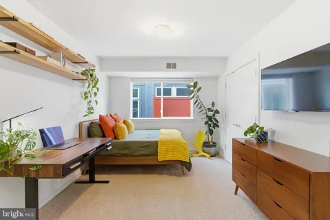a bedroom with furniture and a potted plant