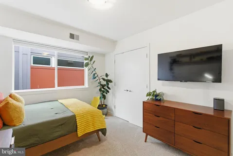 a bedroom with a bed and flat screen tv