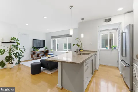 a kitchen with sink and refrigerator