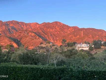a view of a mountain range in a cloudy sky