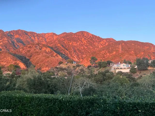 a view of a mountain range in a cloudy sky