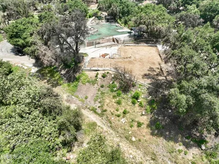 a view of backyard of house with green space