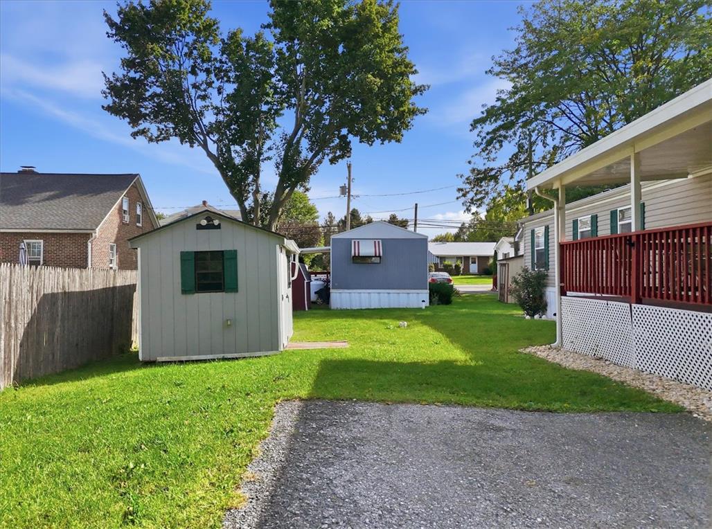 6129 Memorial Road Allentown, PA 18104 - Photo 34 of 46 A spacious grassy lawn provides ample outdoor space alongside a functional detached storage shed.