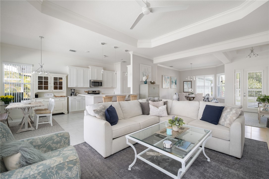 933 Yearling Trail Sebastian, FL 32958 - Photo 17 of 36 a living room with furniture kitchen view and a chandelier