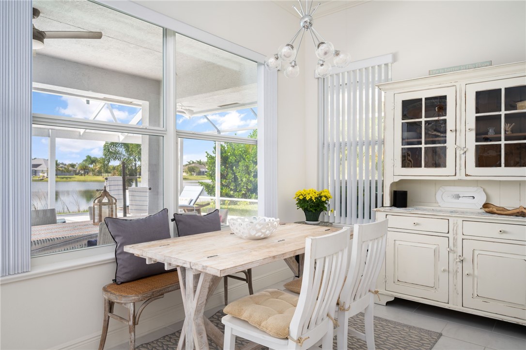 933 Yearling Trail Sebastian, FL 32958 - Photo 22 of 36 a view of a dining room with furniture large windows and wooden floor