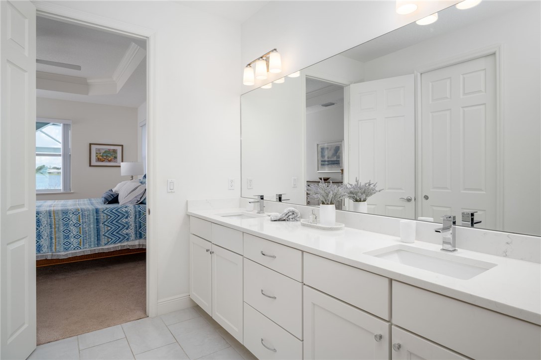 933 Yearling Trail Sebastian, FL 32958 - Photo 28 of 36 a bathroom with double sink and a mirror