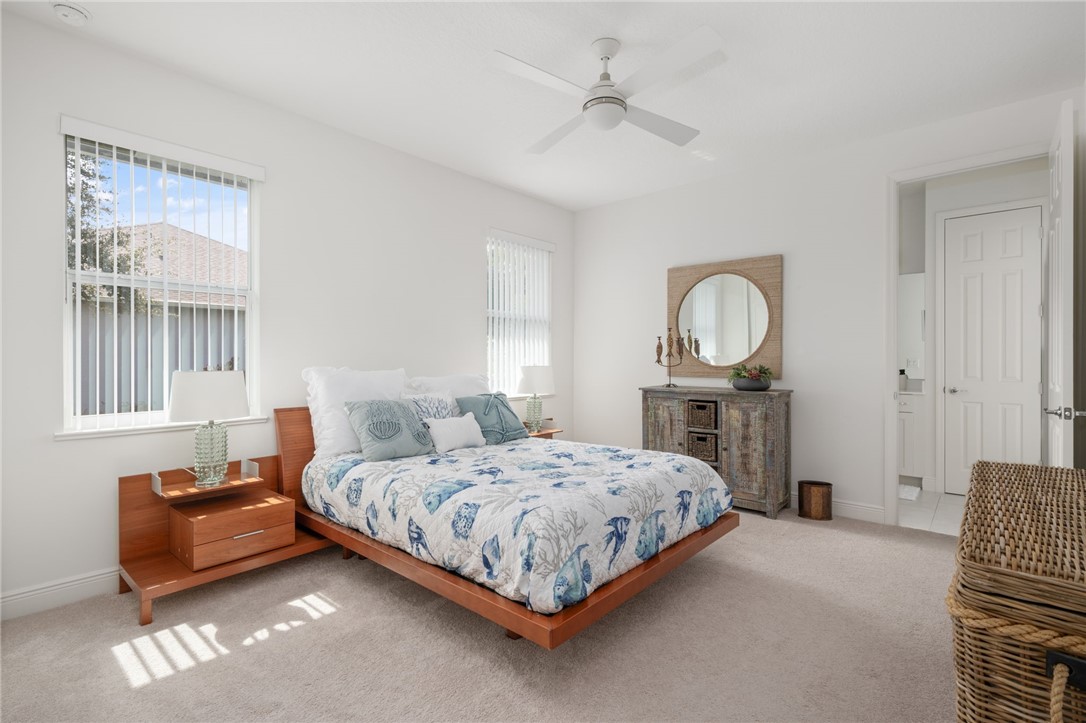 933 Yearling Trail Sebastian, FL 32958 - Photo 32 of 36 a bedroom with a bed window and couch