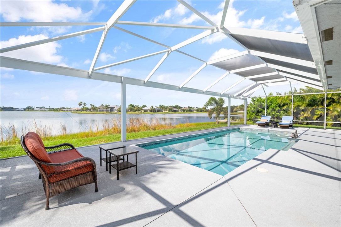 933 Yearling Trail Sebastian, FL 32958 - Photo 7 of 36 a view of swimming pool with a lounge chairs in a patio
