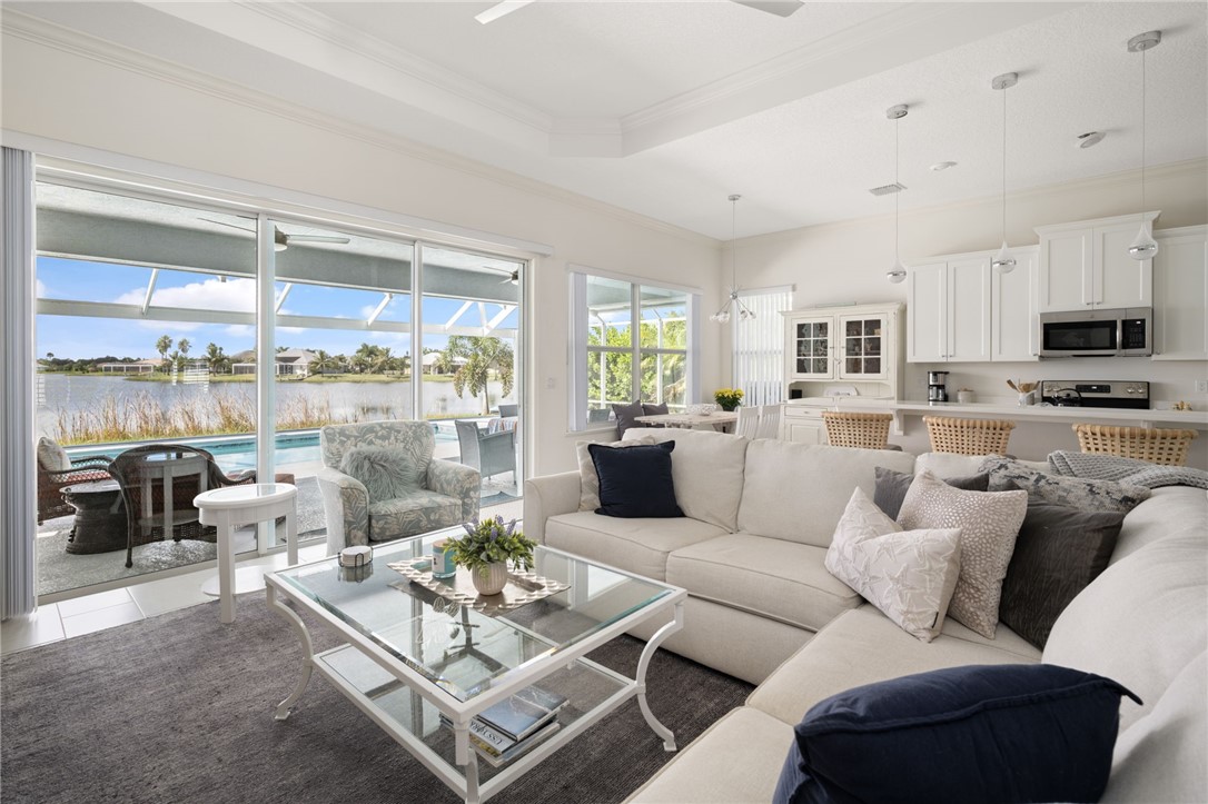 933 Yearling Trail Sebastian, FL 32958 - Photo 10 of 36 a living room with furniture large windows and a view of kitchen