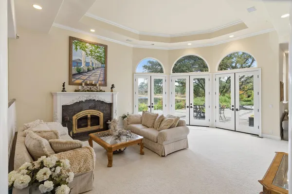 a living room with furniture a large window and dining table