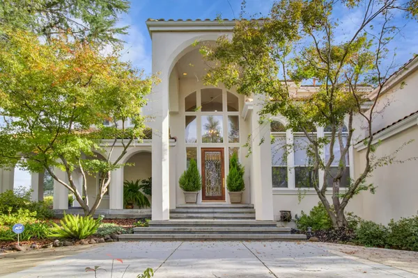 a front view of a house with a garden