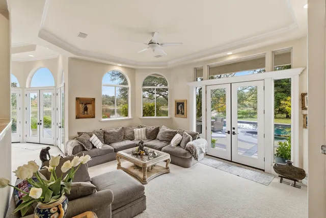 a kitchen with granite countertop a stove a sink a dining table and chairs