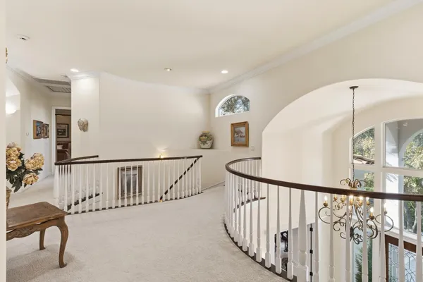 a living room with furniture a flat screen tv and a large window