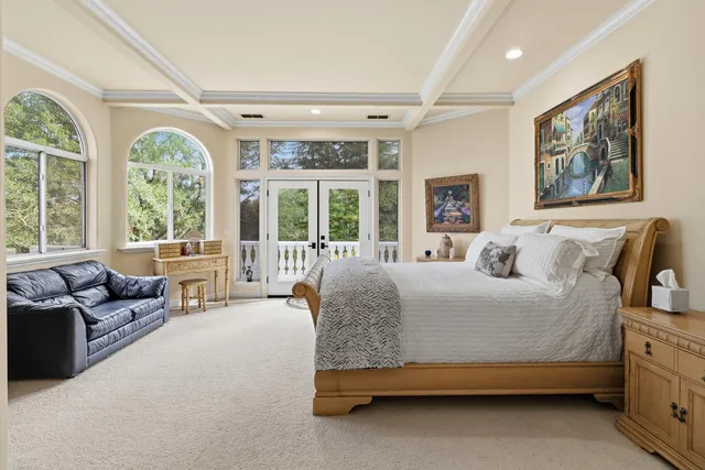 a living room with furniture a flat screen tv and a large window