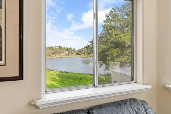 a spacious bedroom with a bed and a large window