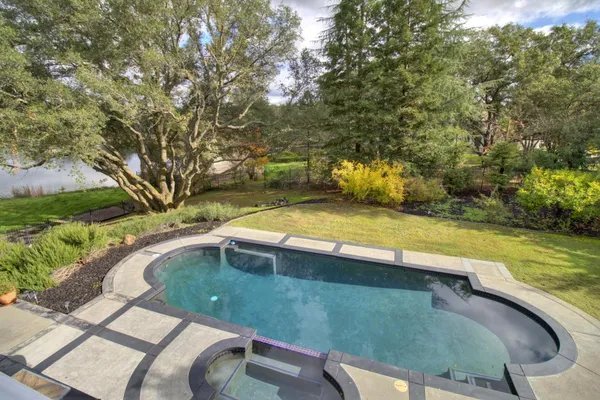 a view of a swimming pool with a yard