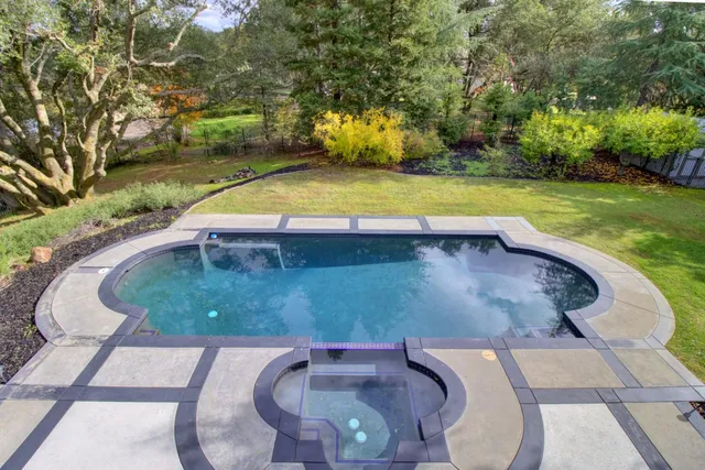a front view of a house with swimming pool and porch