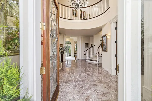 a front view of a house with a fountain