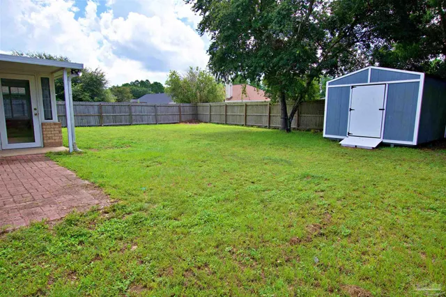a view of backyard with tub and trees