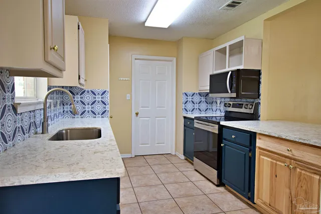 a kitchen with a sink stove and refrigerator