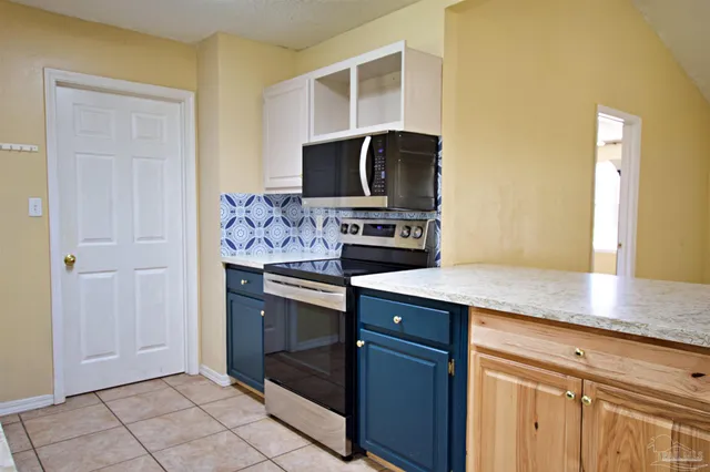 a kitchen with stainless steel appliances granite countertop a sink and a stove