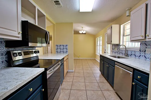 a kitchen with a sink stove and microwave