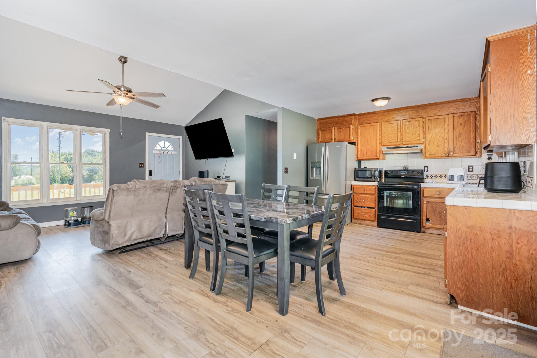 716 McDaniel Road Kings Mountain, NC 28086 - Photo 11 of 35 a view of a dining room with furniture window and wooden floor