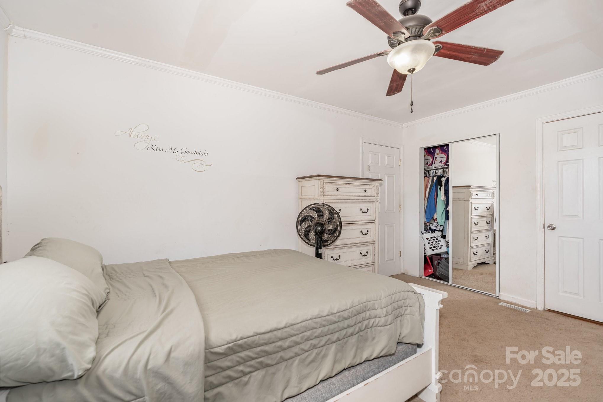 716 McDaniel Road Kings Mountain, NC 28086 - Photo 18 of 35 a bedroom with a large bed and a chandelier