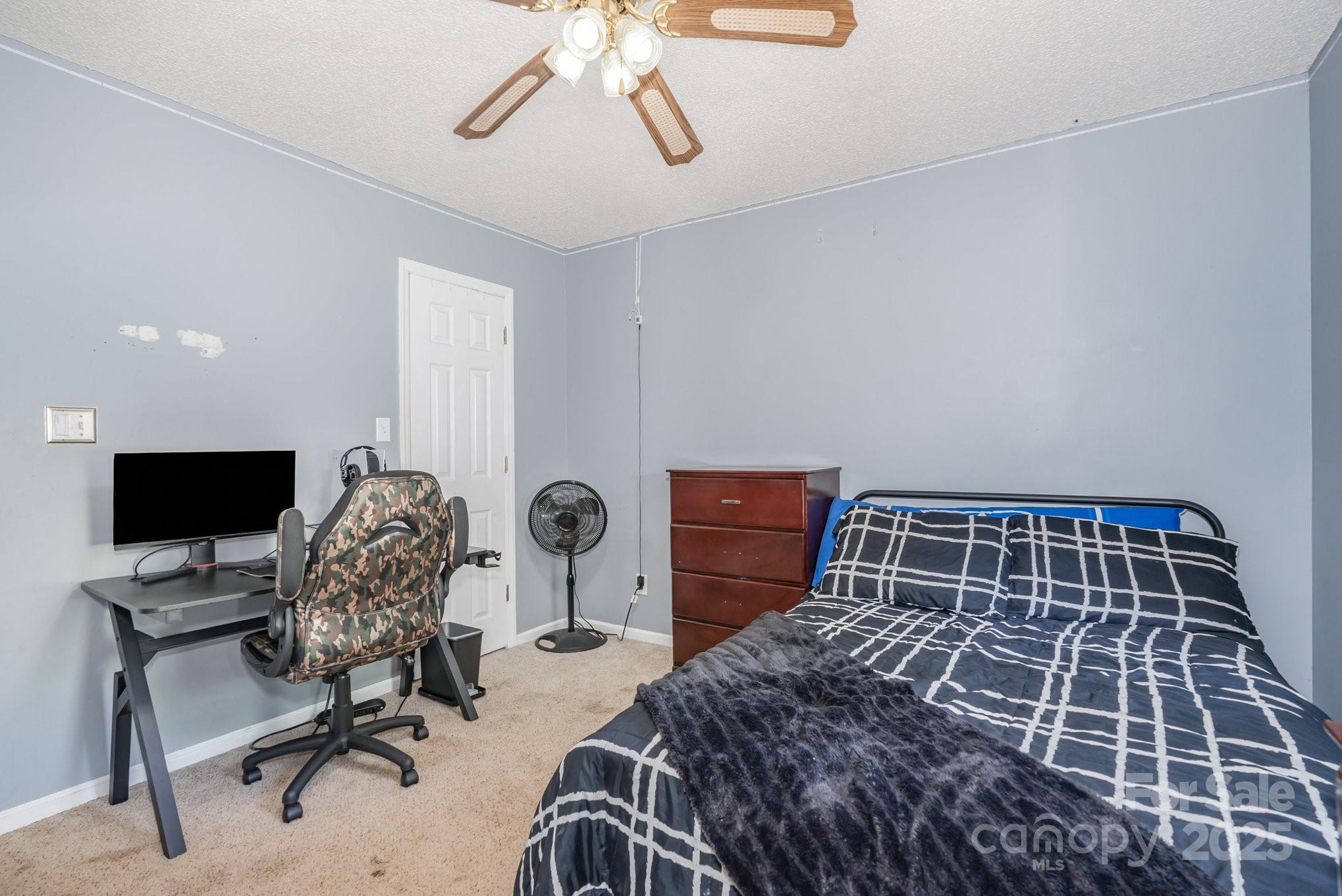 716 McDaniel Road Kings Mountain, NC 28086 - Photo 27 of 35 a bedroom with a bed and a desk
