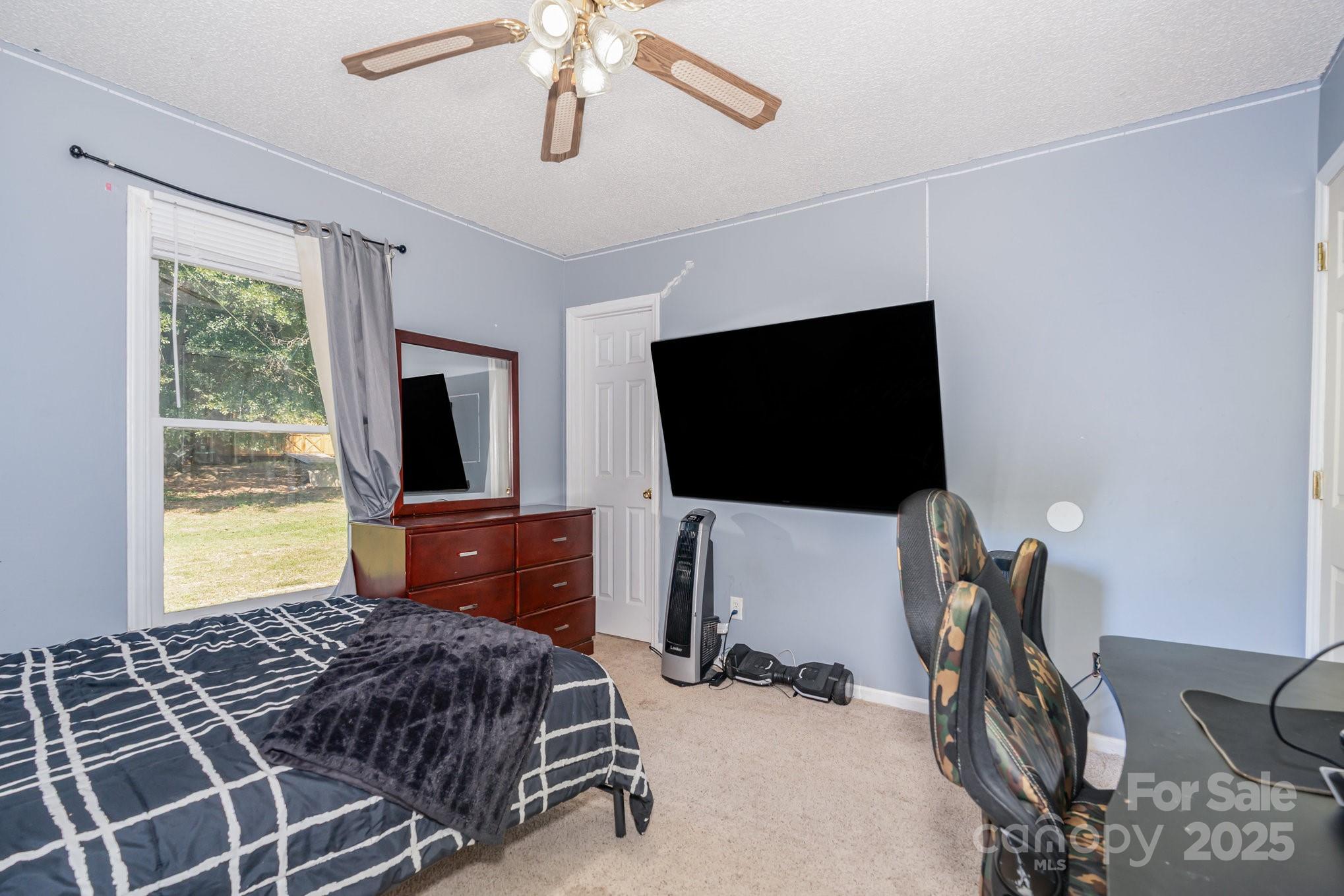 716 McDaniel Road Kings Mountain, NC 28086 - Photo 28 of 35 a bedroom with a bed and a flat screen tv