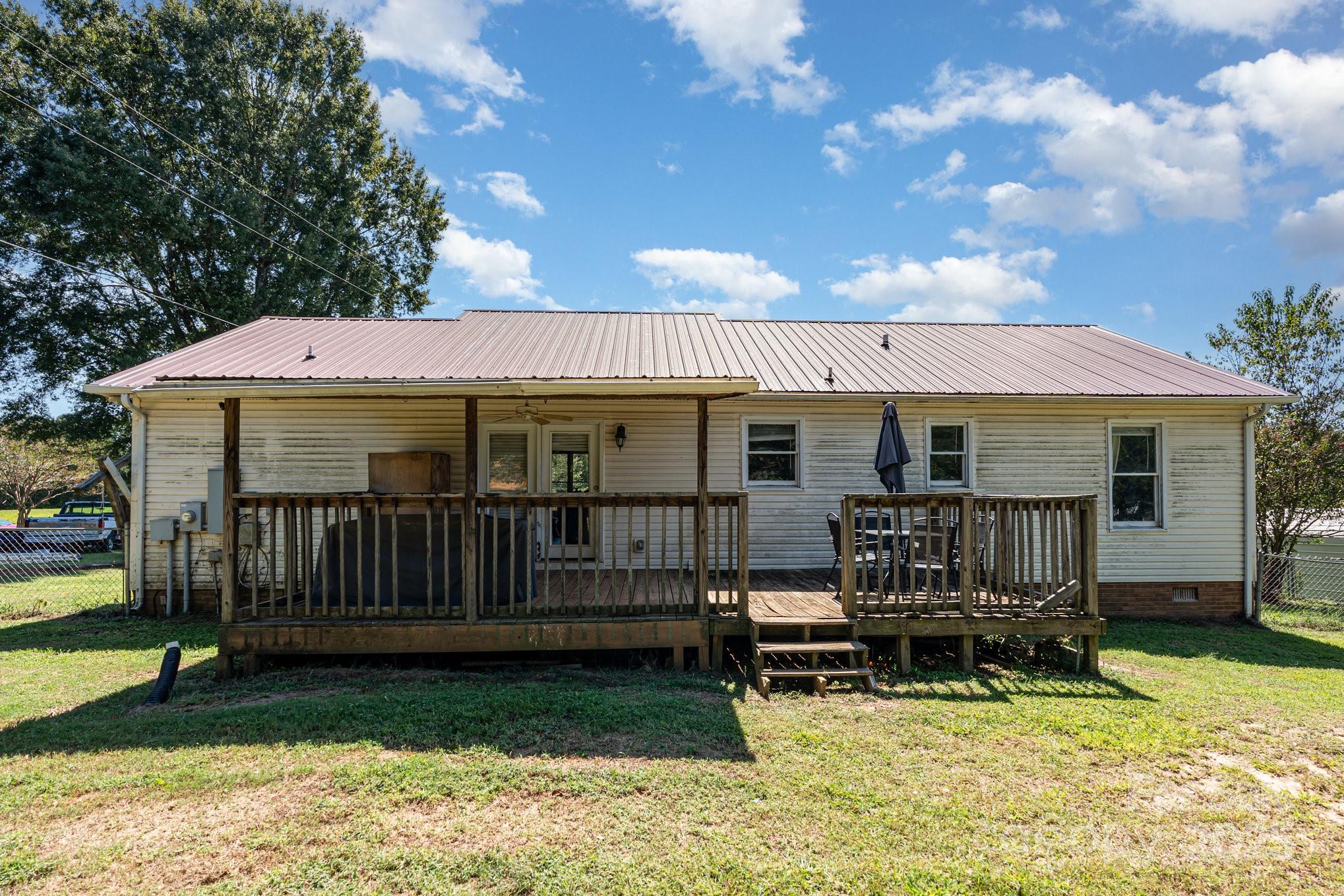 716 McDaniel Road Kings Mountain, NC 28086 - Photo 31 of 35 a view of a house with wooden deck and a yard