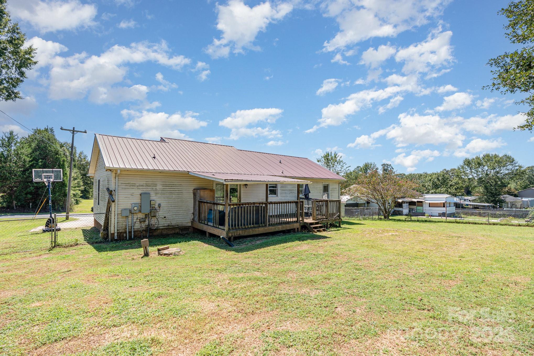 716 McDaniel Road Kings Mountain, NC 28086 - Photo 33 of 35 a view of a swimming pool with lawn chairs and a big yard