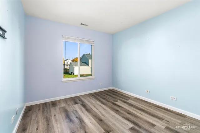 a view of room with window and hardwood floor