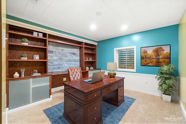 a living room with furniture a rug and a bookshelf
