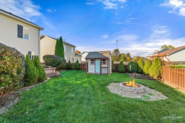 a view of a house with a backyard and a patio