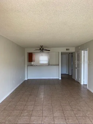 an empty room with kitchen