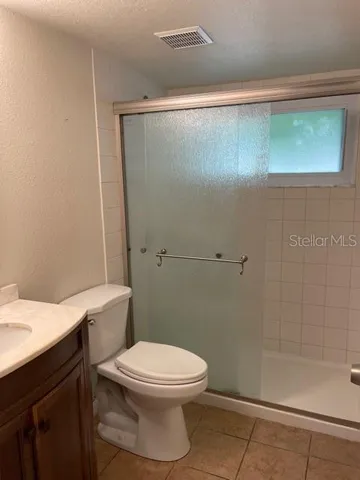a bathroom with a toilet a sink and shower