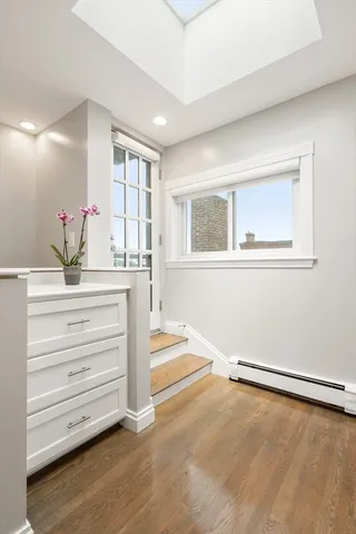 a room with a dresser and a window