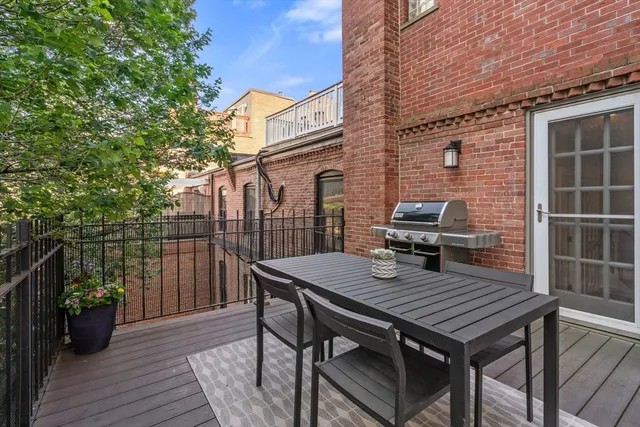 a view of a deck with wooden floor and seating space