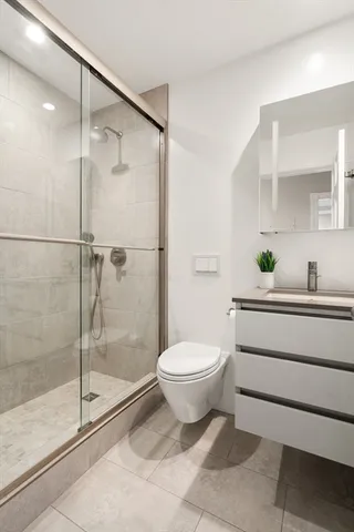 a bathroom with a toilet sink and shower