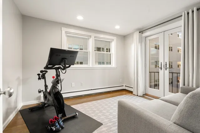 a living room with furniture gym equipment and a window