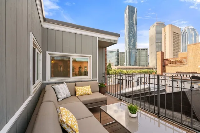 a view of a balcony with furniture