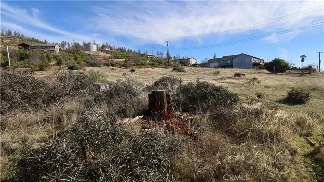 a view of a field with a building in the background