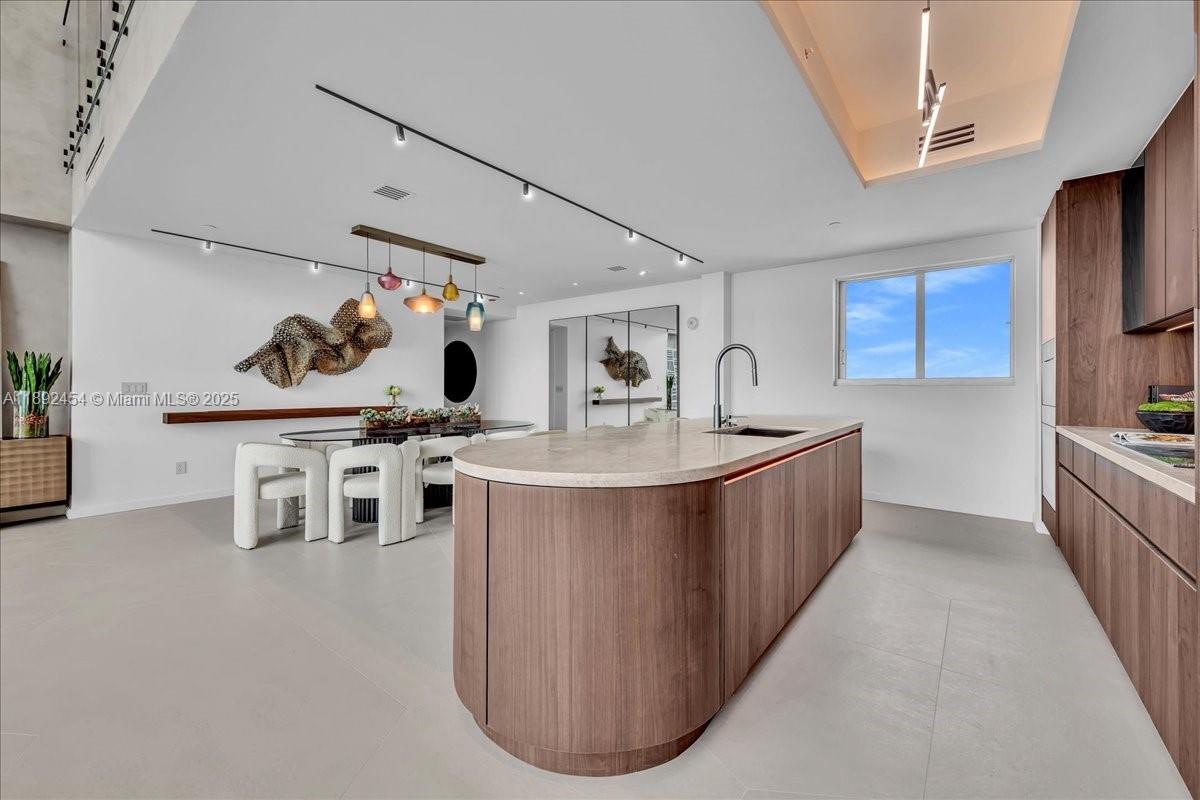 888 Biscayne Boulevard, Unit PH5704 Miami, FL 33132 - Photo 17 of 62 a kitchen with stainless steel appliances kitchen island granite countertop a sink and a refrigerator