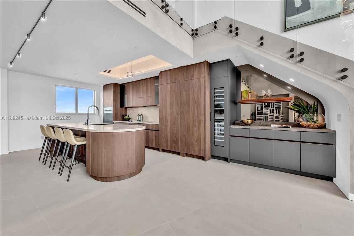 888 Biscayne Boulevard, Unit PH5704 Miami, FL 33132 - Photo 18 of 62 a kitchen with refrigerator and cabinets