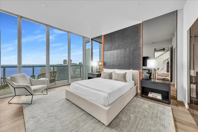 a view of a hallway with wooden floor and windows