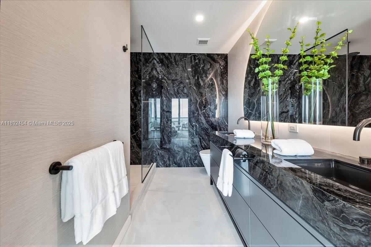 888 Biscayne Boulevard, Unit PH5704 Miami, FL 33132 - Photo 31 of 62 a living room with furniture a plant and a large window