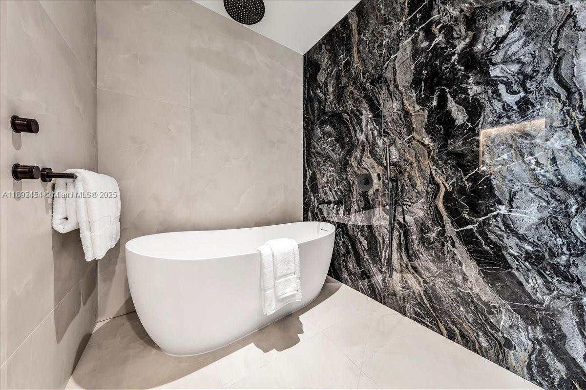 888 Biscayne Boulevard, Unit PH5704 Miami, FL 33132 - Photo 32 of 62 a white tub sitting next to a white wall